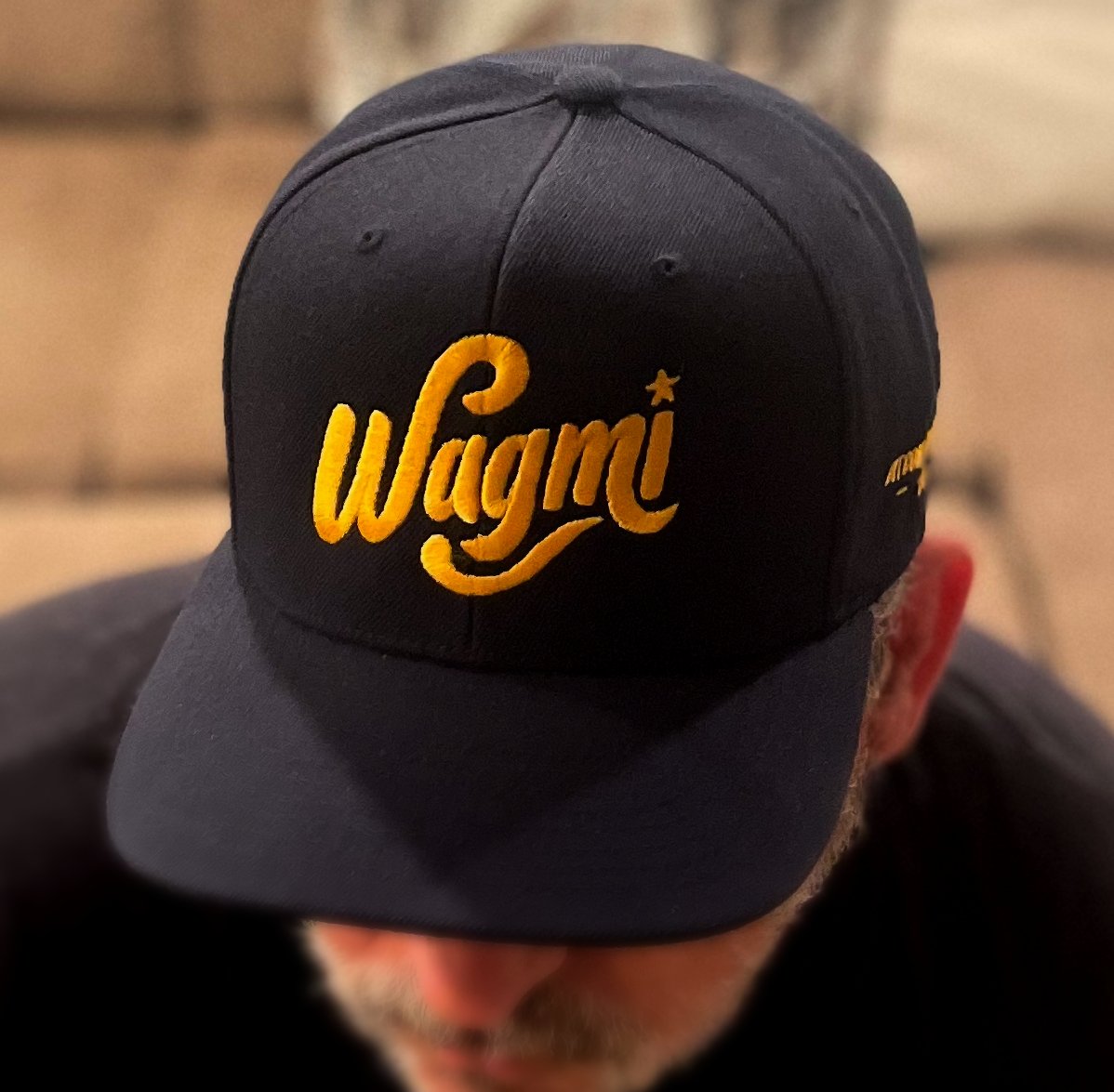 Dark Navy snapback hat with yellow bitcoin logo and WAGMI 'We’re All Gonna Make It' text for crypto optimism - Sovereign Goods.