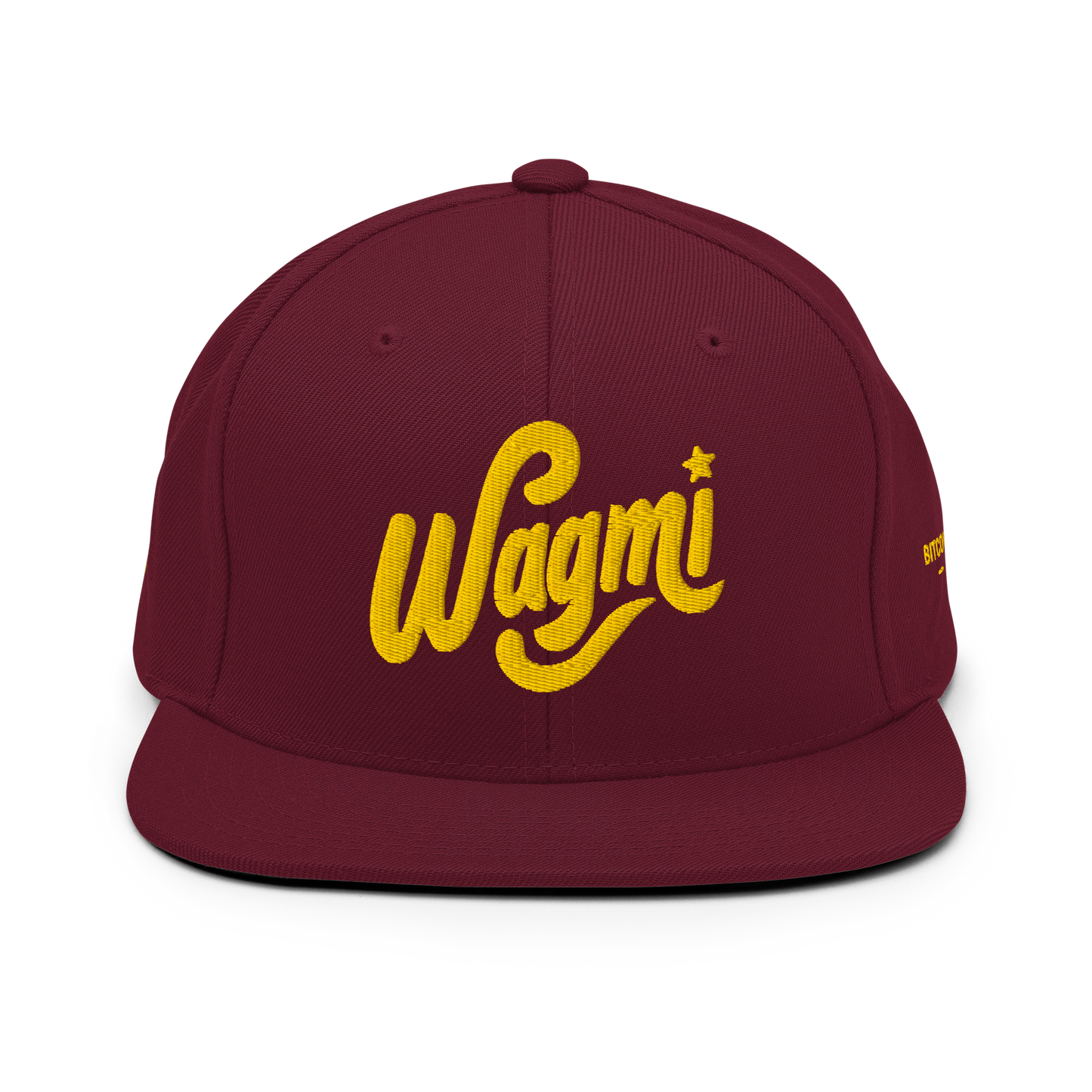 A maroon snapback hat with the text 'Wagmi' written in yellow script on the front panel.